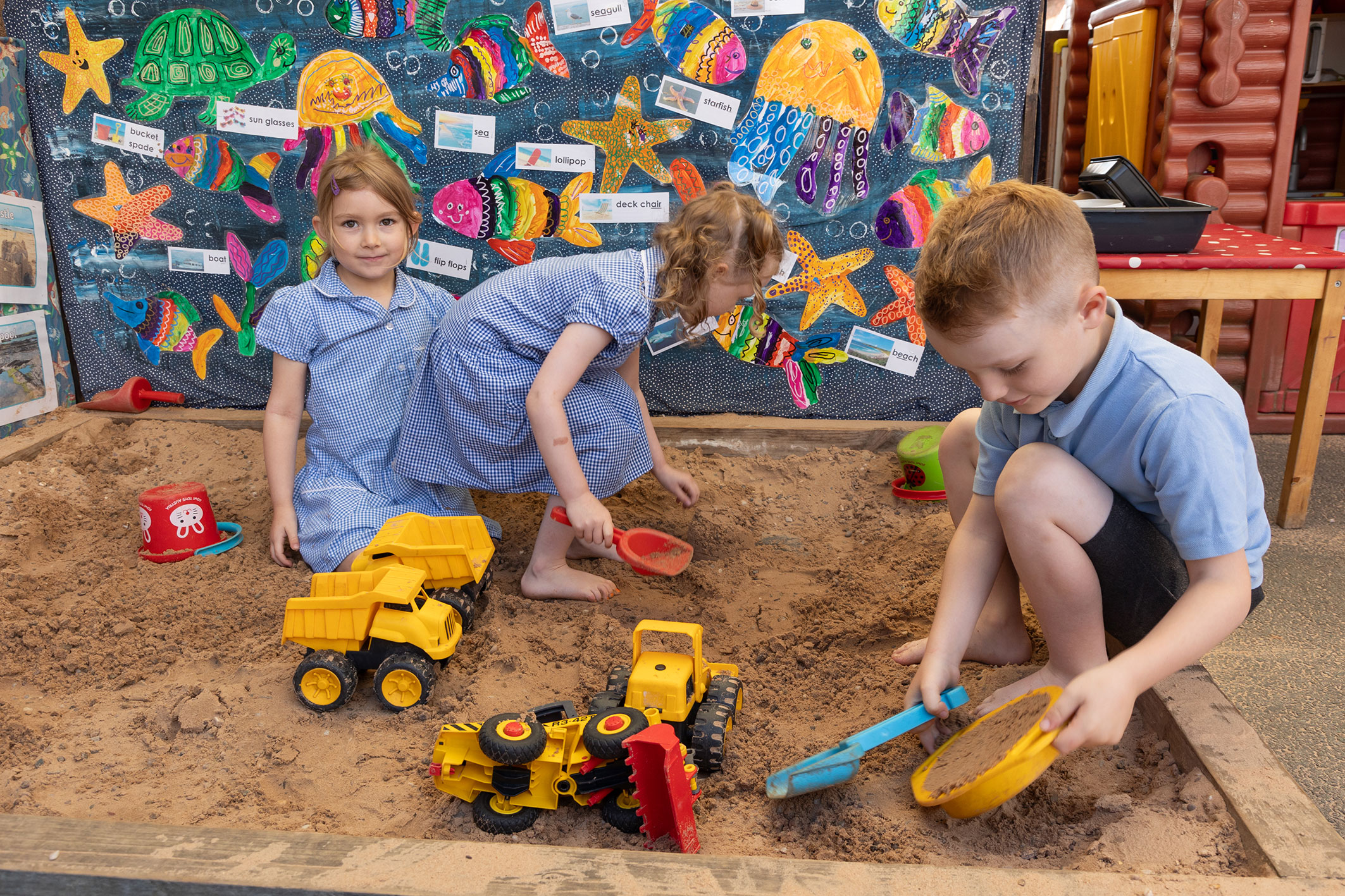 TNT-E24-11073-sm.jpg EYFS children playing in the sandpit